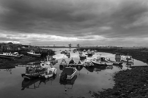 Black and white photograph of the boats at Paddy's hole and industrial Teesside.
