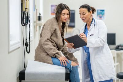 A patient sitting and talking to a carpal tunnel long-term specialist.