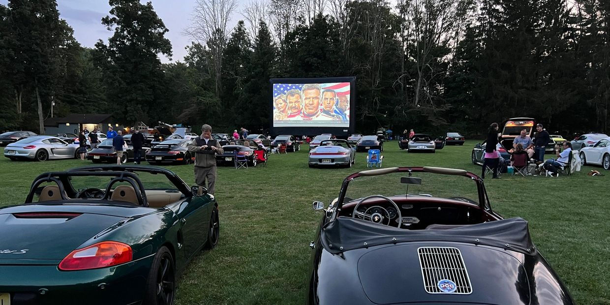 Porsche drive-in movie night on Extreme 55’ outdoor movie screen with audio played through FM radio