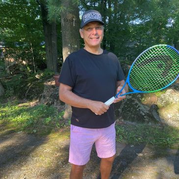 BUCKMINDSET owner Steven Buck playing tennis with official baseball cap and tennis rachet