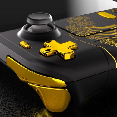 Close-up of a black and gold gaming controller with intricate designs.