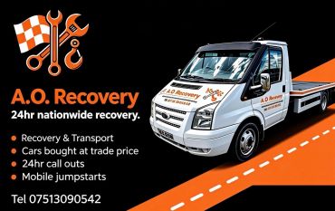 A.O. Recovery flatbed truck with service details and contact number.