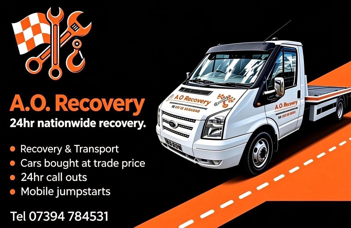 A.O. Recovery advertising truck with contact details and services.