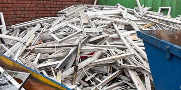 Pile of used uPVC window frames ready for recycling during collection in Liverpool