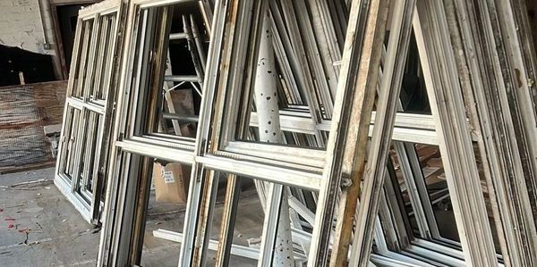 Scrap PVC window frames stacked for collection in the North West