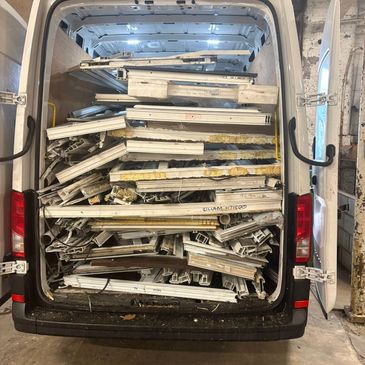 uPVC scrap window frames loaded onto a collection vehicle in Manchester ready for recycling.
