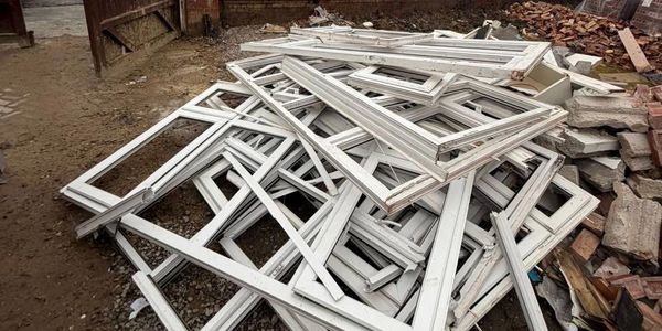 uPVC window frames at an installer site in Bolton ready to collect for recycling