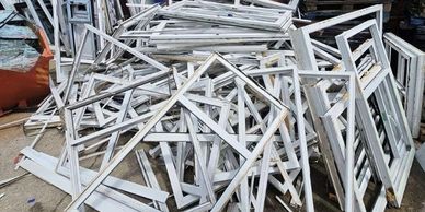 Pile of old uPVC window frames ready for recycling collection in the North West