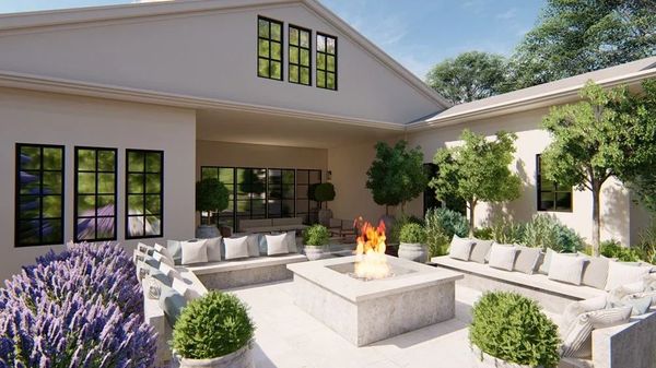 Elegant outdoor patio area, in the center is a modern custom square fire pit.