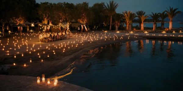 Outdoor beach dinner with candle lights at night.