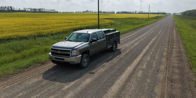 KB Heavy Duty mobile service truck on a rural road in Central Alberta