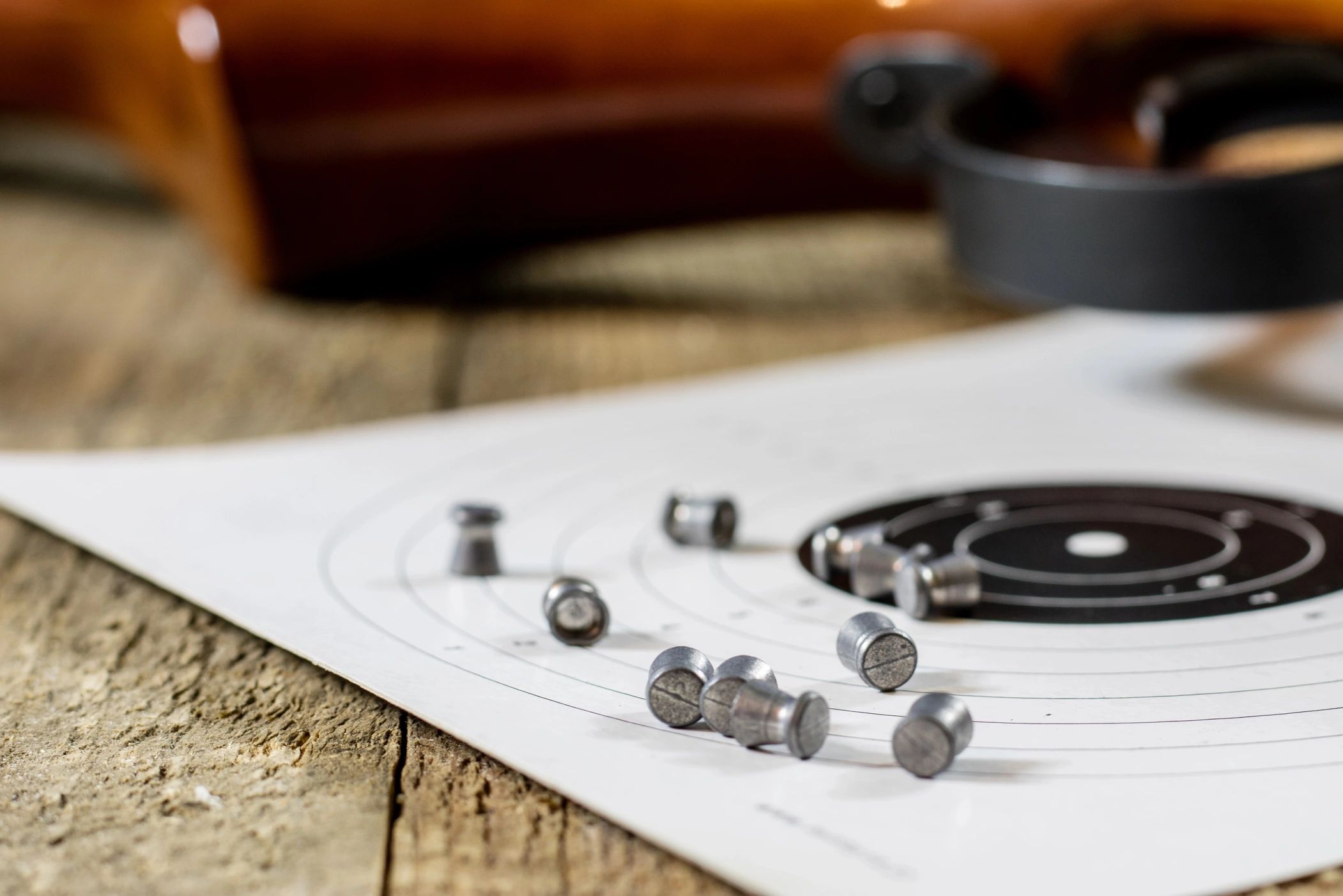 An air gun with pellets and a target.