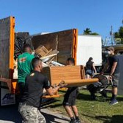 Team loading truck with junk removed from a home.