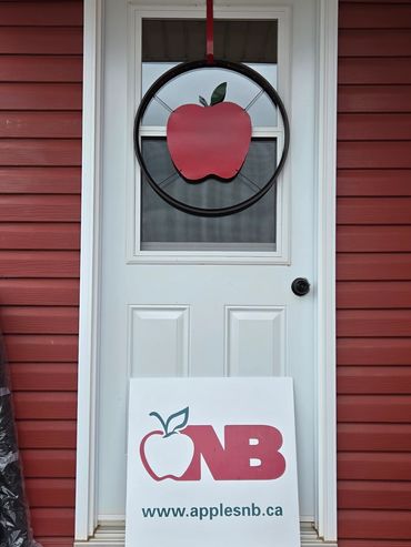 White door with red apple decoration and applesnb.ca sign.