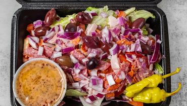 Antipasto salad with tomato, red onion, kalamata olives, thin pepperoni and salami chopped, oven bak