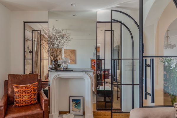 Cozy modern living room with brown leather chair and decorative fireplace.