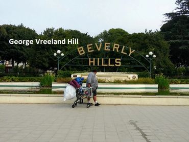 A homeless man at the Beverly Hills Sign in Beverly Hills, California.