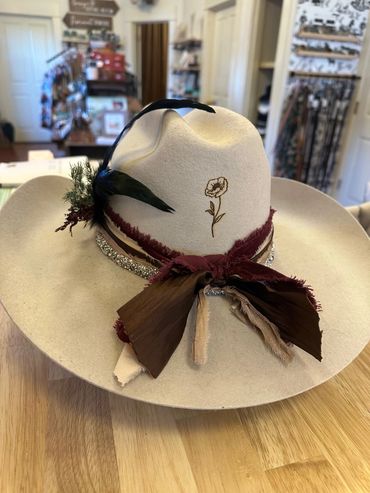 A custom designed western felt hat worn ribbons and a floral design