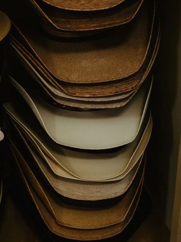 A stack of straw cowboy hats