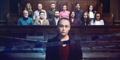A woman stands in front of a jury in a courtroom.
