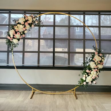 Circular golden frame with floral decorations.