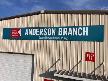 ACM Signs on Warehouse Exterior