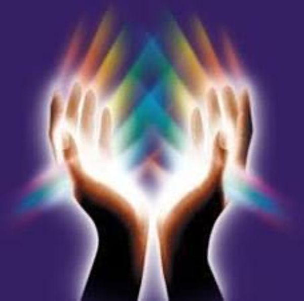 Glowing hands releasing multicolored light beams against a dark background.