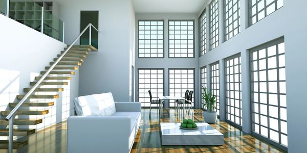 Bright modern living room with large windows and minimalist furniture.