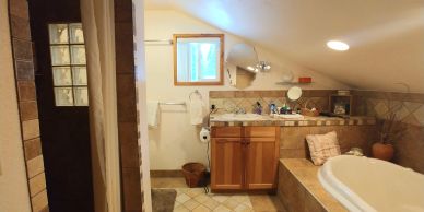 Cozy bathroom with wooden cabinets and a bathtub.