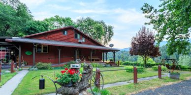 Rustic house with garden and trees.
