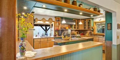 Cozy kitchen with wood cabinets and flowers.