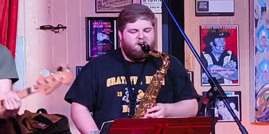 Man playing saxophone on stage.