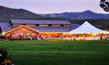Wedding reception at Stillwater Ranch with barn, tent, and mountain views.