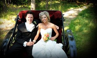 Bride and groom seated in a horse-drawn carriage at Stillwater Ranch.