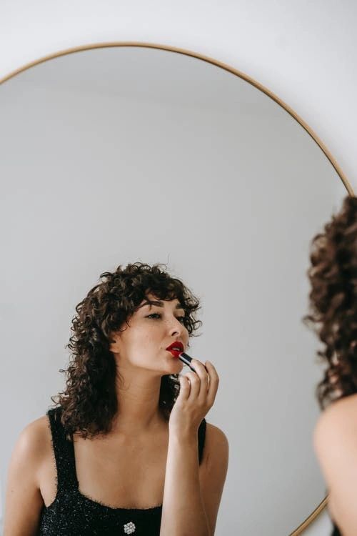 woman applying lipstick