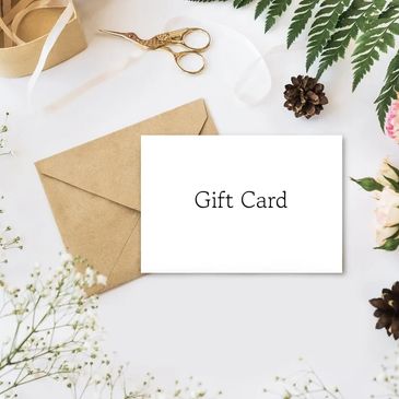 Elegant gift card with floral and rustic decor on a white surface.