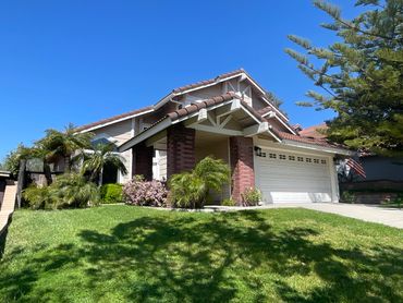 Painted house with a big green yard