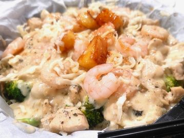Queen of Soul combines garlicky shrimp with chicken and topped with grilled pineapples.