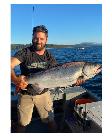 A happy angler showing his catch with Wildside Adventures.