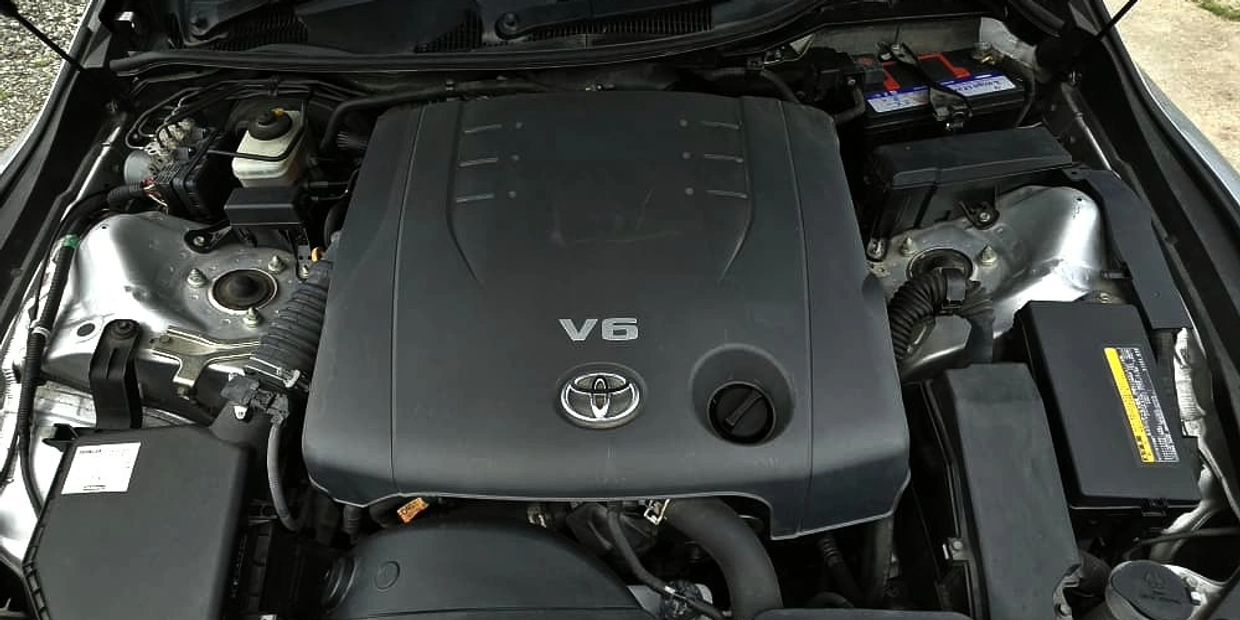 Toyota V6 engine inside a car.