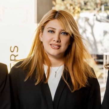 Young woman with blonde hair smiling.