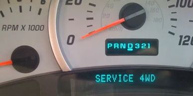 Car dashboard showing a 'SERVICE 4WD' warning message.