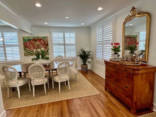Bright dining room with wooden floors and classic furniture.