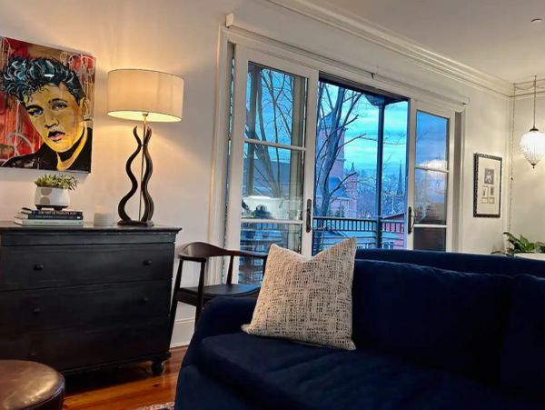 Cozy living room with blue sofa and artistic lamp.