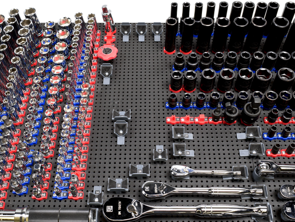 tool grid socket and ratchet holders holding tools on a tool grid board with some missing tools