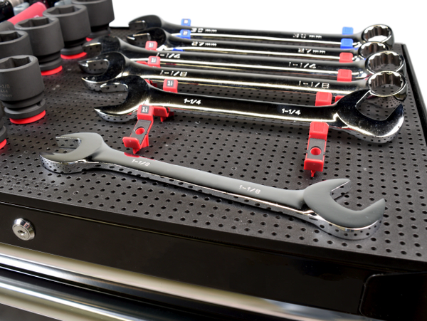 close up of large wrench holders holding wrenches on a tool grid board on the top of a tool box