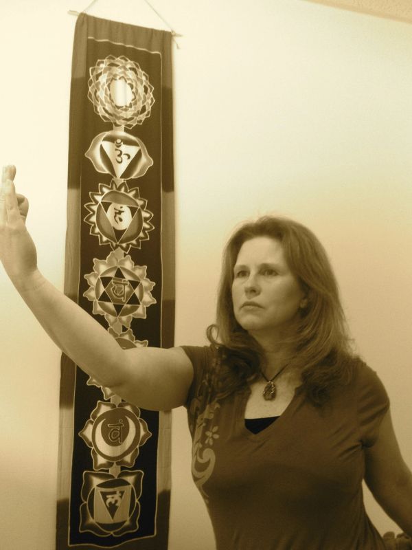 Woman practicing meditation or energy work.