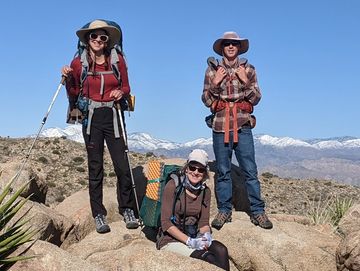 Family of three posing in front of Mt. San Gorgonio.