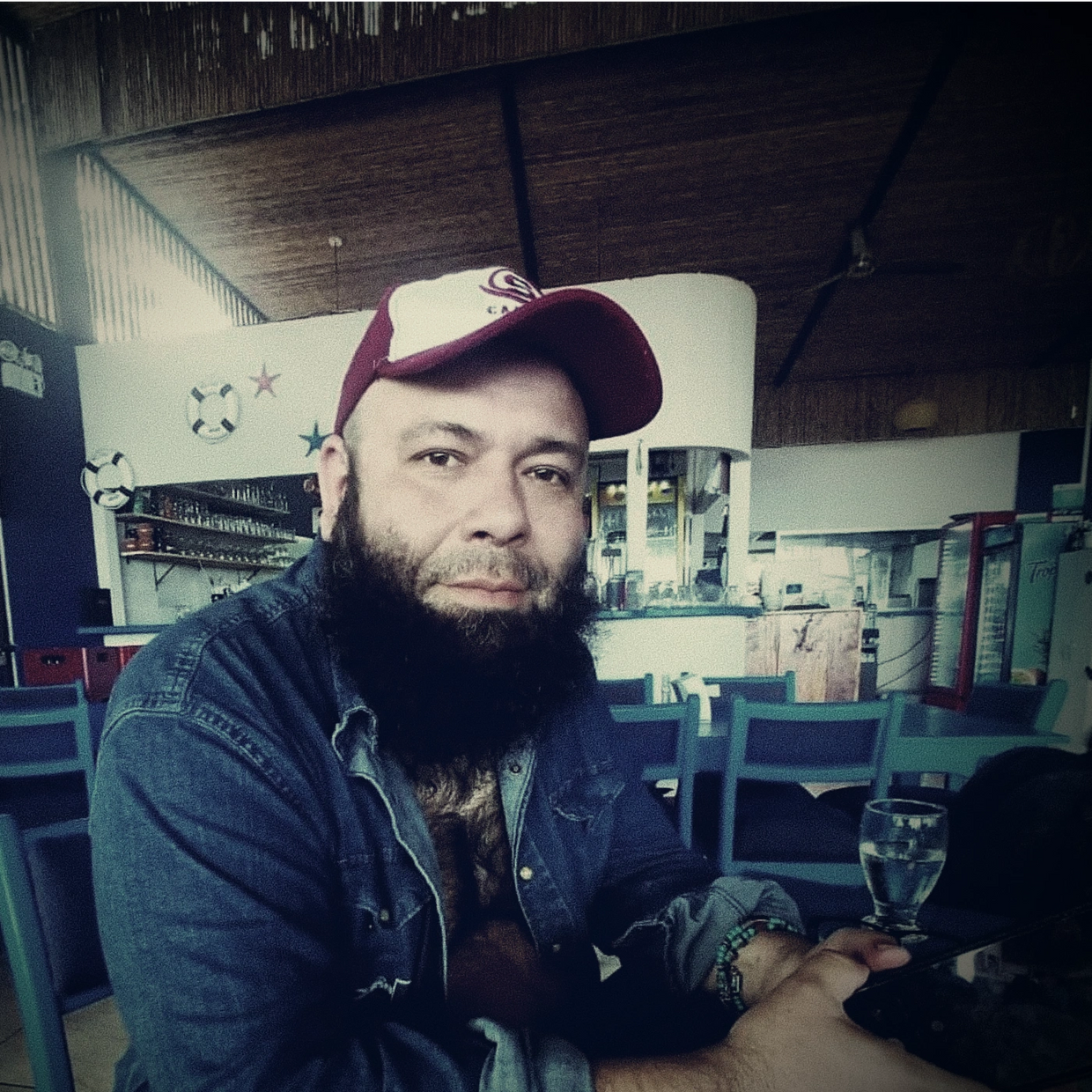 Gerry Arias seated in a café in Costa Rica, promotional photo for Sweetest Melody single (2025)