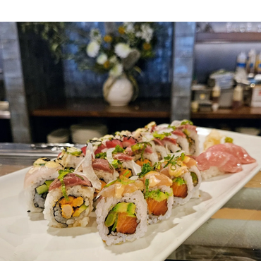 Assorted sushi rolls beautifully arranged on a white plate.